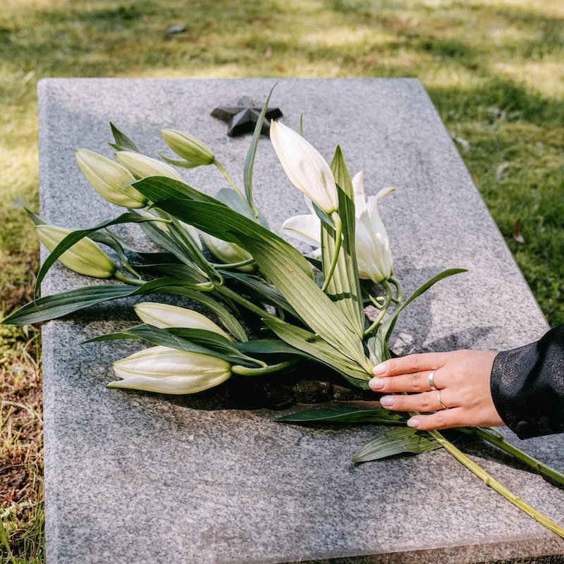 granite memorial with flowers placed on top