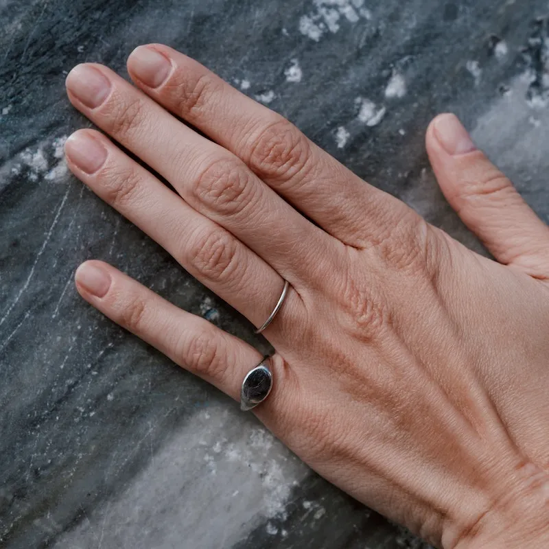 hand touching a granite gravestone